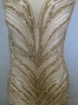 Picture of Long dress with golden crystals and feathers