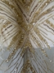 Picture of Long dress with golden crystals and feathers