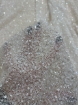 Picture of Mesh-type embroidery with pearls, beads, and white sequins.