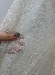 Picture of Mesh-type embroidery with pearls, beads, and white sequins.