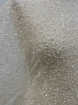 Picture of Mesh-type embroidery with pearls, beads, and white sequins.