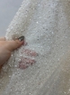 Picture of Mesh-type embroidery with pearls, beads, and white sequins.